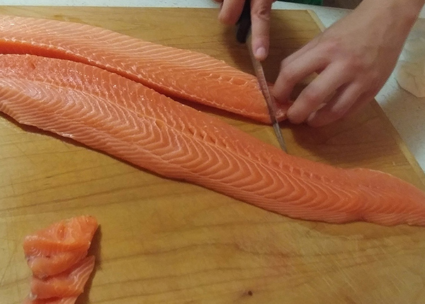 Person filets salmon