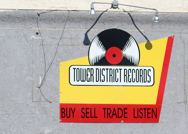 A wall with a decal that says Tower District Records