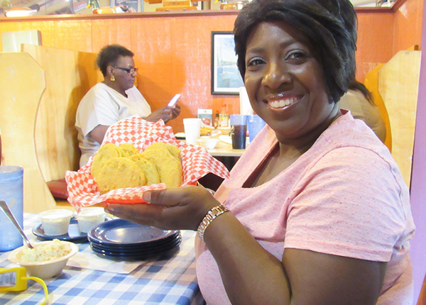 Woman smiles and holds a basket of food