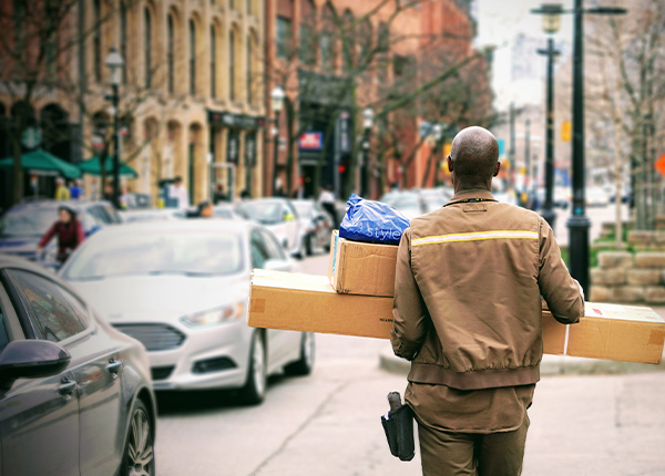 UPS driver carrying packages