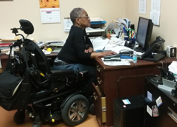 Woman in a wheelchair works at a computer
