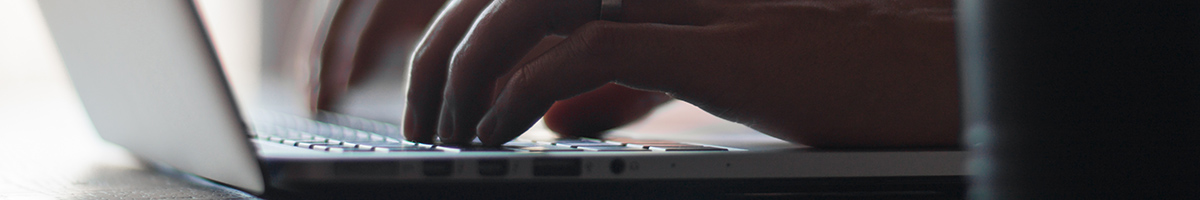 Chapter banner: hands typing on laptop keyboard
