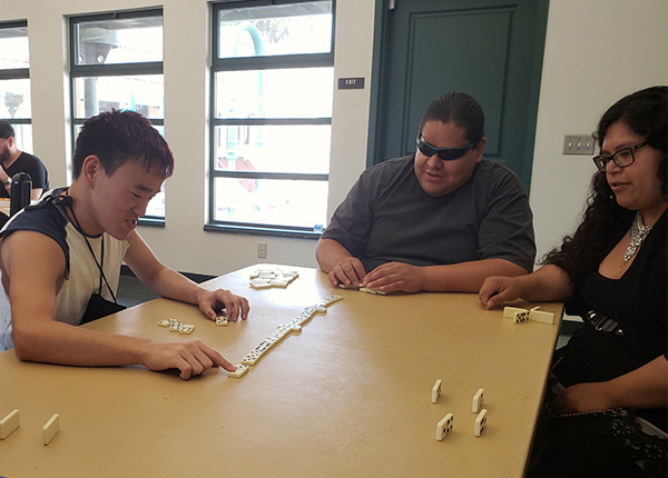 People play dominoes