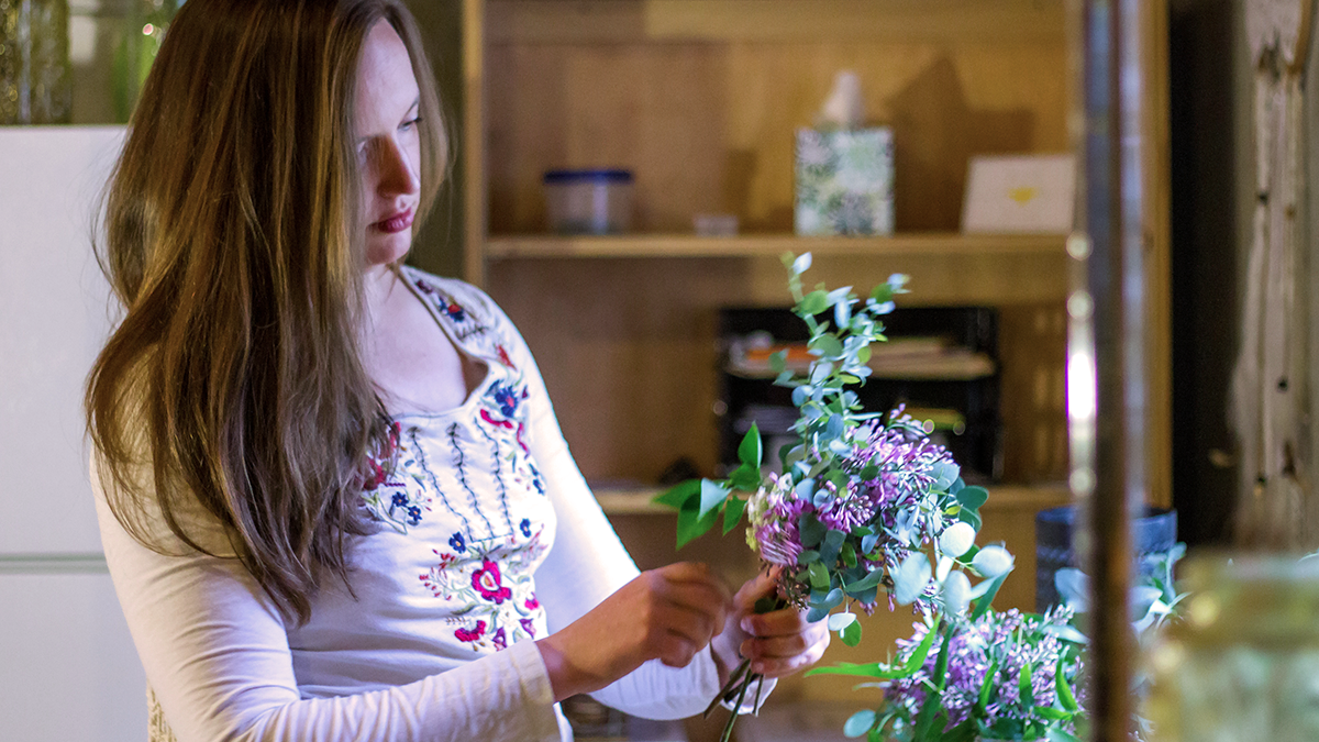 Woman making a floral arrangement
