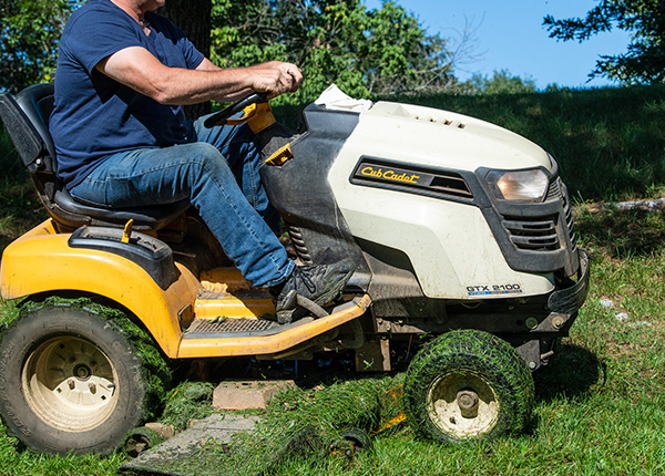 Person on riding lawn mower