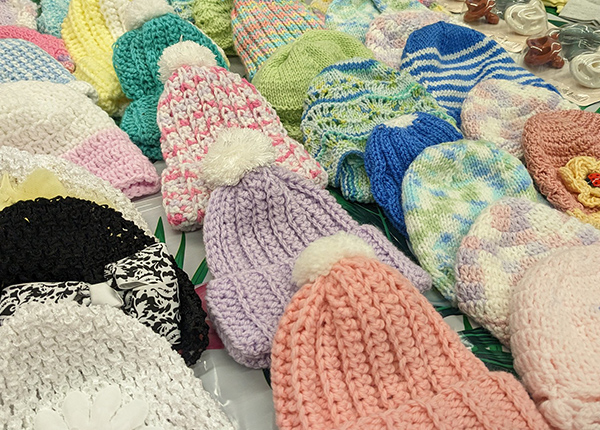 Knitted hats for sale on a table