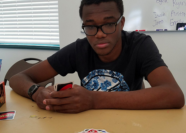 Young man holds Uno cards