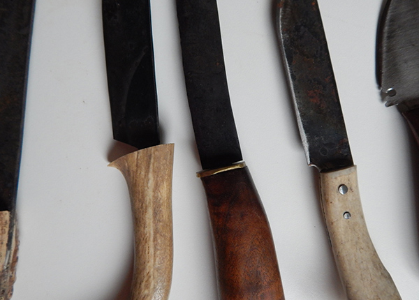 Five knives on a table top