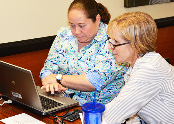 Two women looking at a laptop