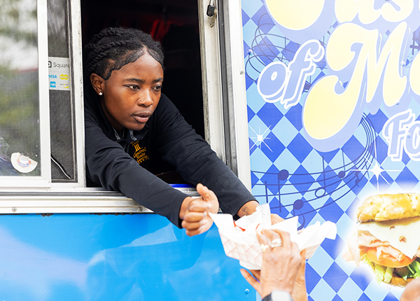 Woman handing food out of a food truck's window