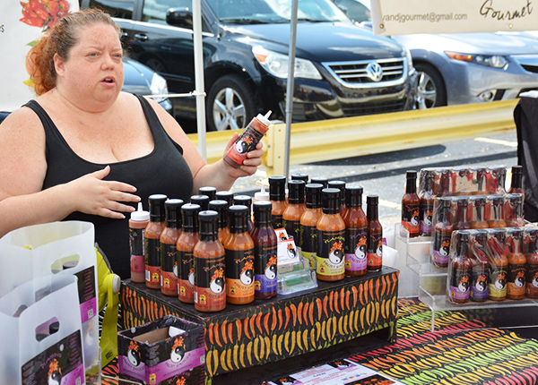 Woman selling hot sauce at a market