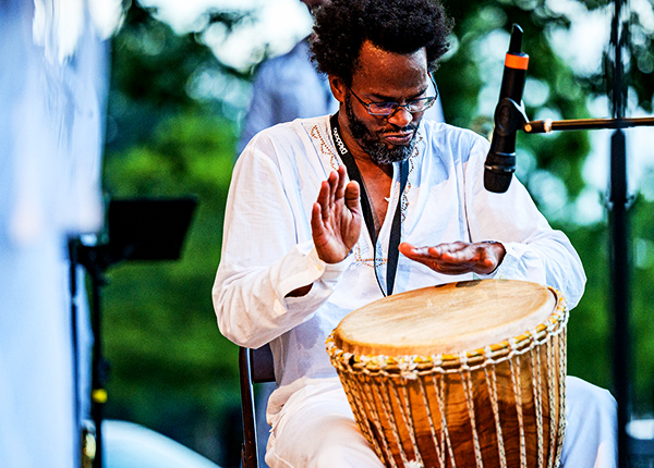 Man playing a drum at an outdoor event