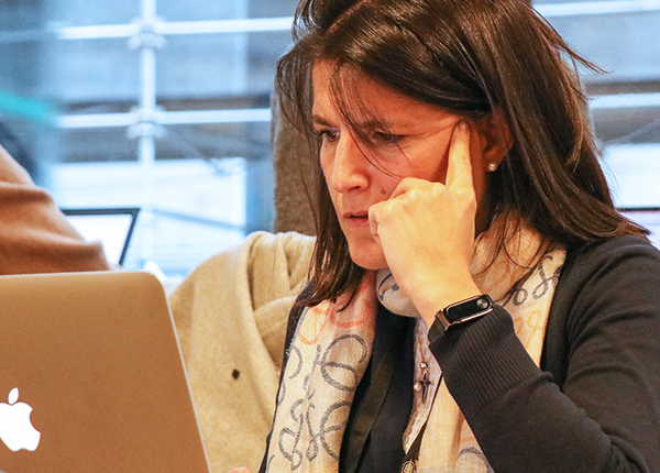 Woman deep in thought looking at a laptop screen