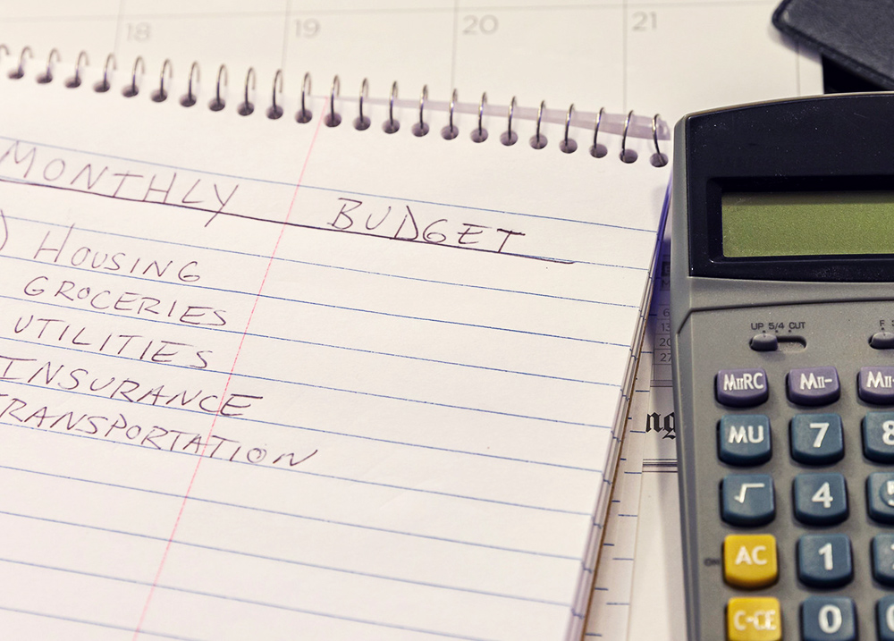 Notebook that has a monthly budget written in it