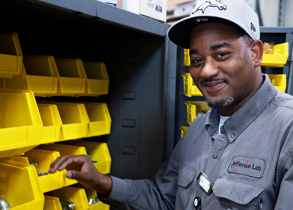 Man standing by plastic organizers used to store hardware