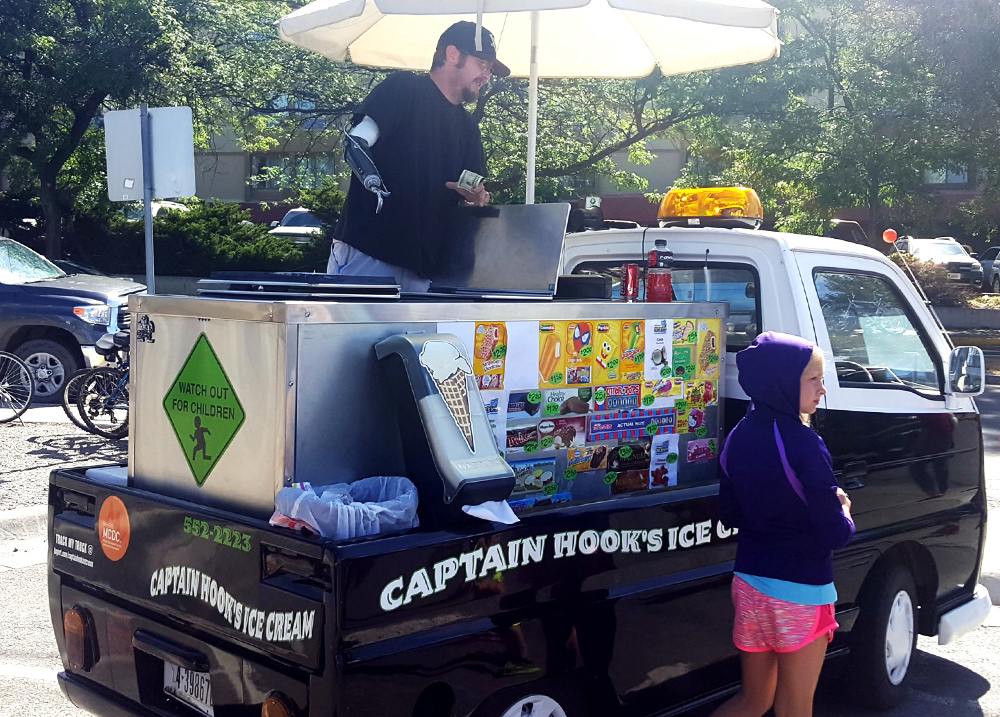 Man with prosthetic arm running an ice cream truck