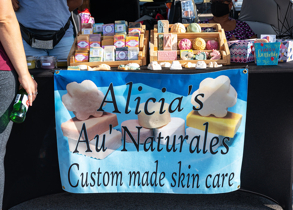 Sign at a vendor stand that says Alicia's Au Naturales - Custom made skin care