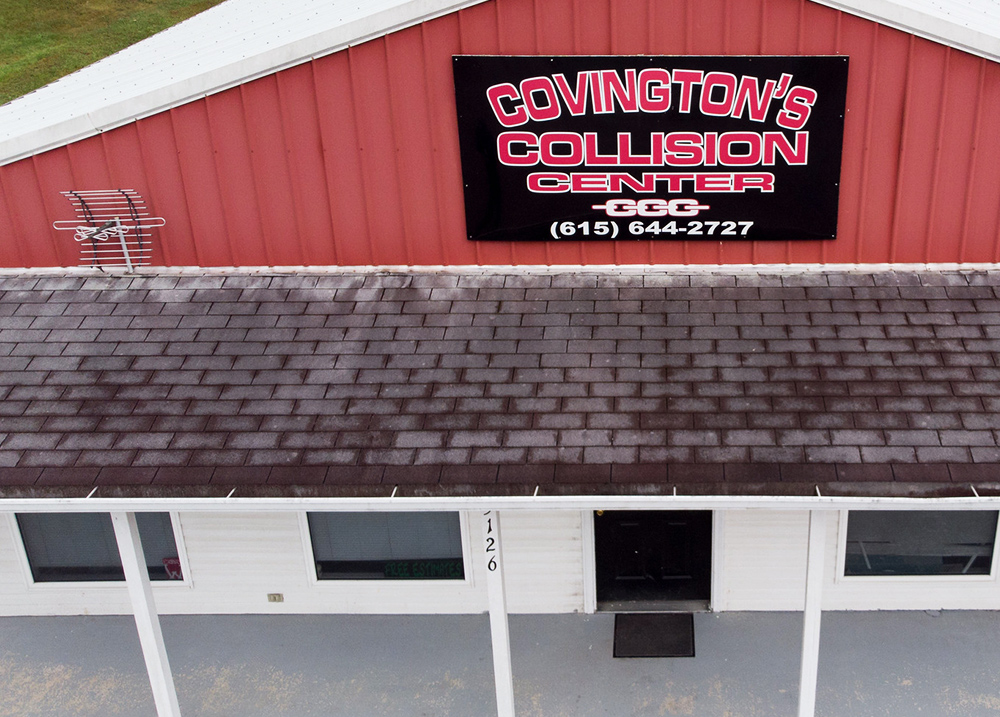 Auto body shop with a large Covington's Collision Center sign on the front