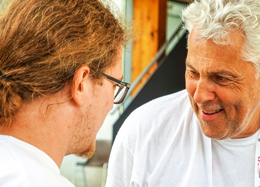 An older man encouraging a younger person