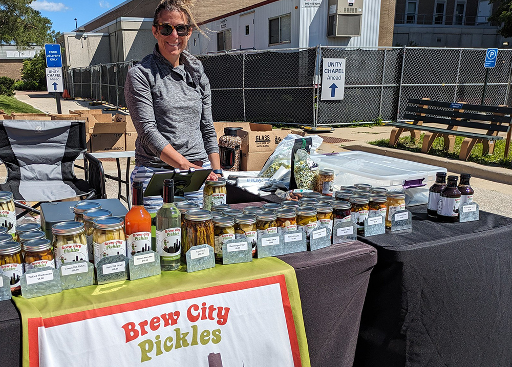Woman selling pickles at an outdoor event