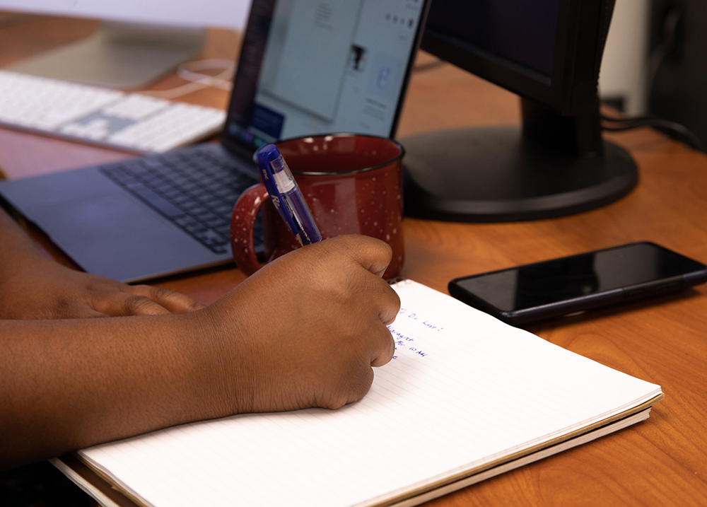 Person writing in notebook