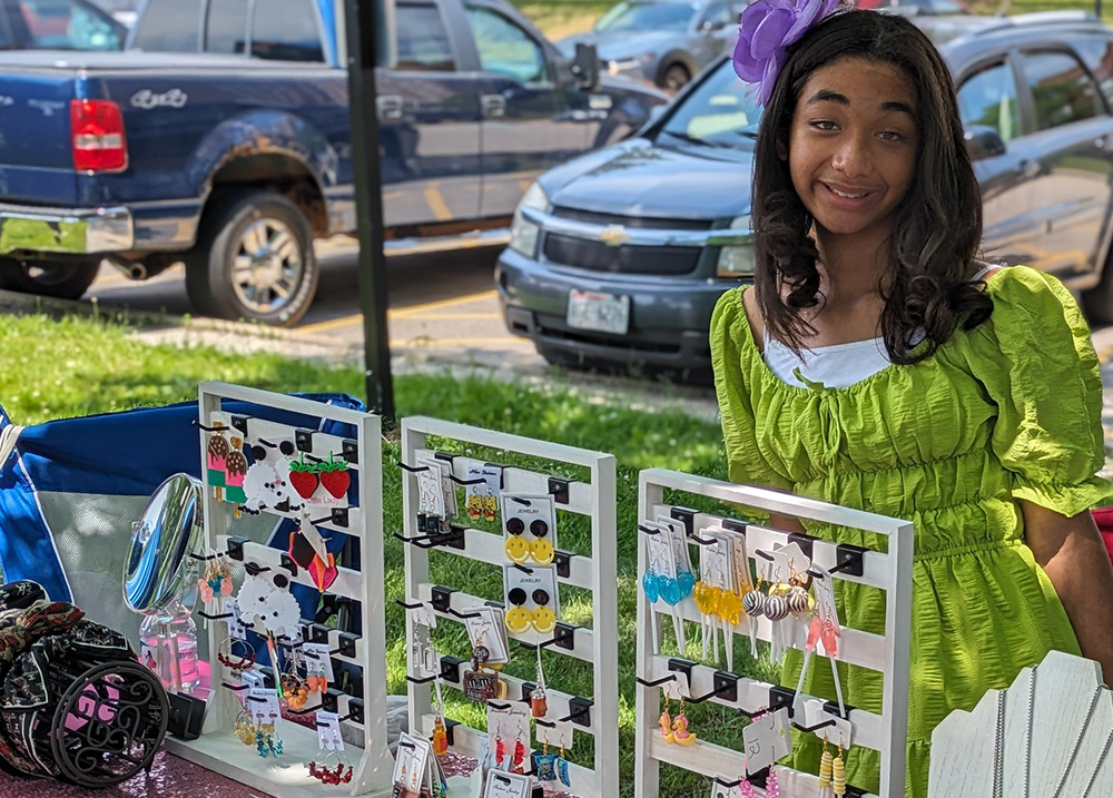 Young woman selling earrings