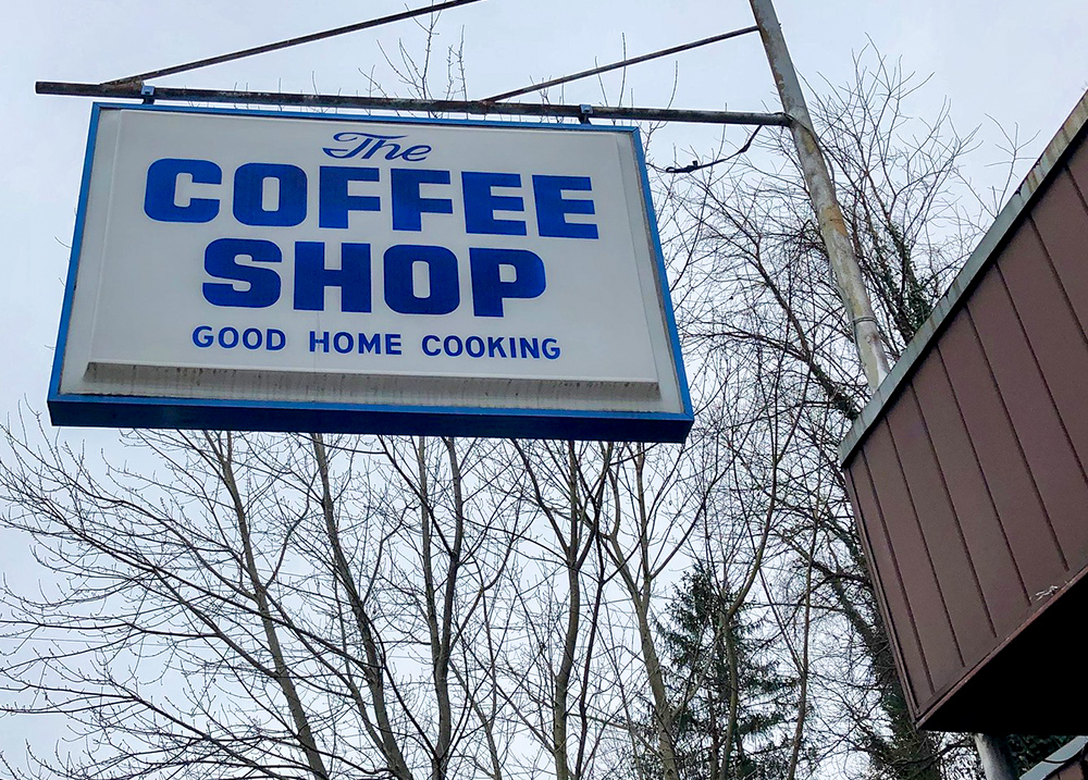Sign hanging over a business that says The Coffee Shop