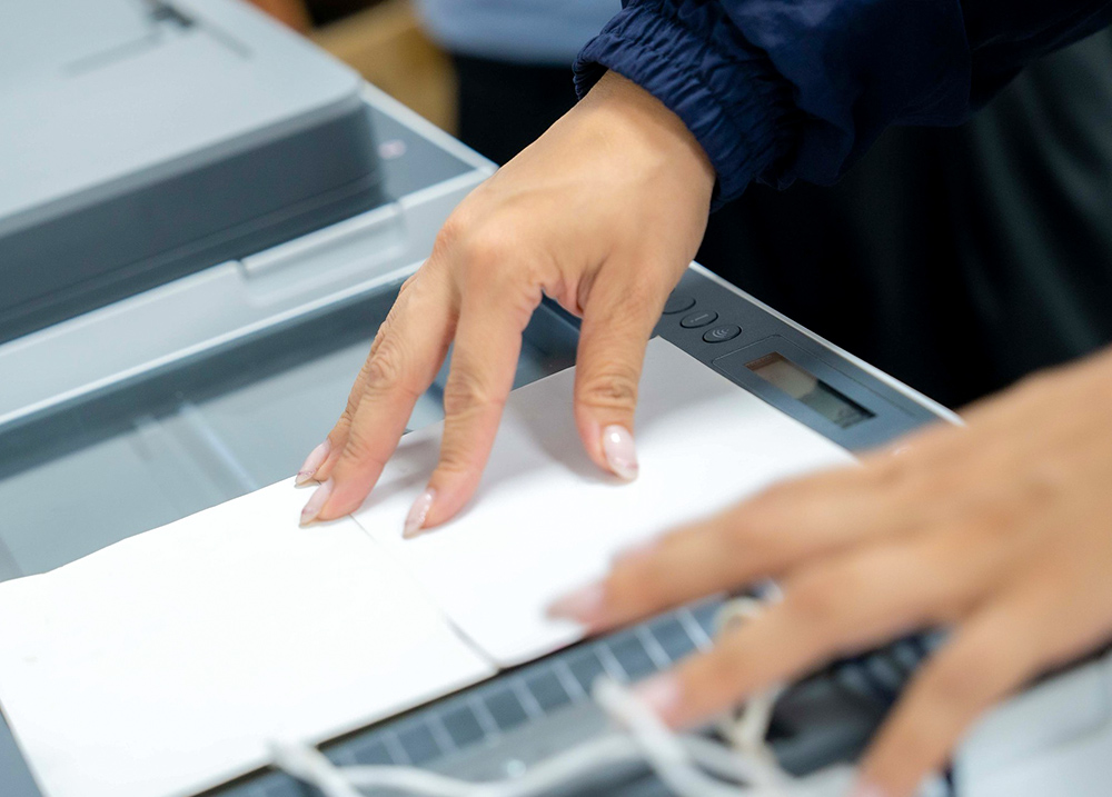 Person scanning something on a Xerox machine
