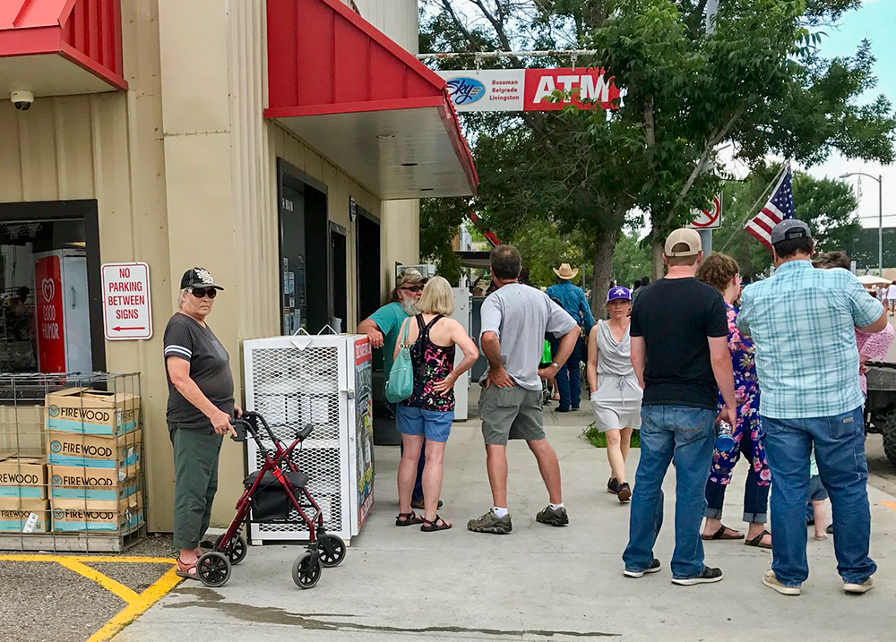 People gathered in front of a convenience store