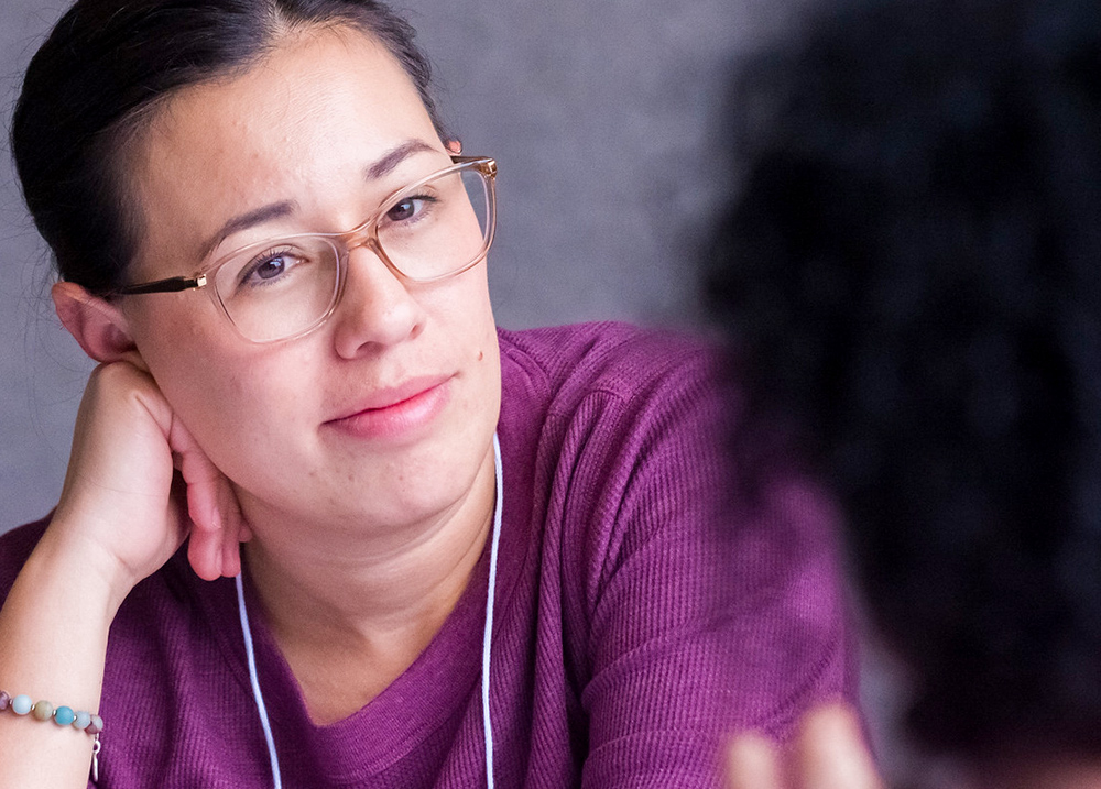 Person listening with their head resting on their hand