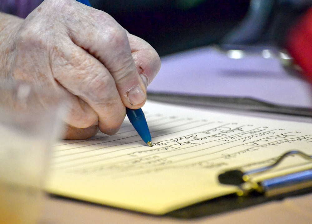 Person writing on a notepad