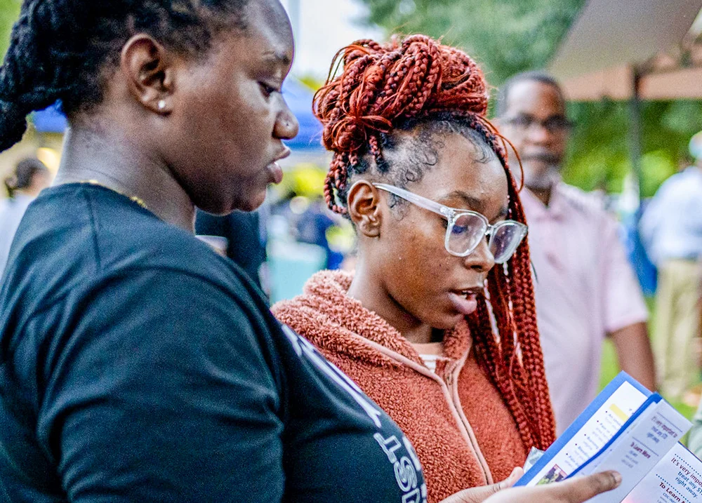 Two people looking at pamphlets