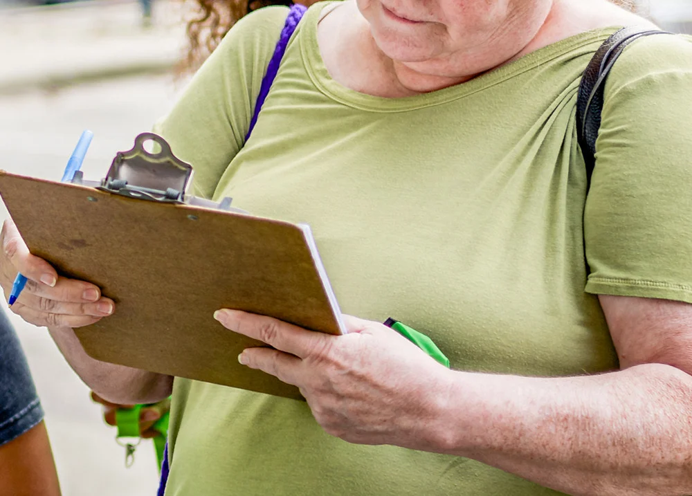 Person looking at a piece of paper on a clipboard