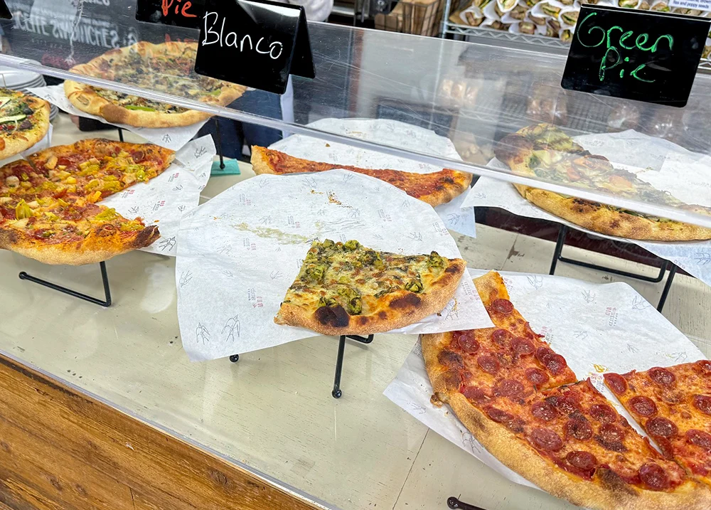 Slices of pizza in a display case