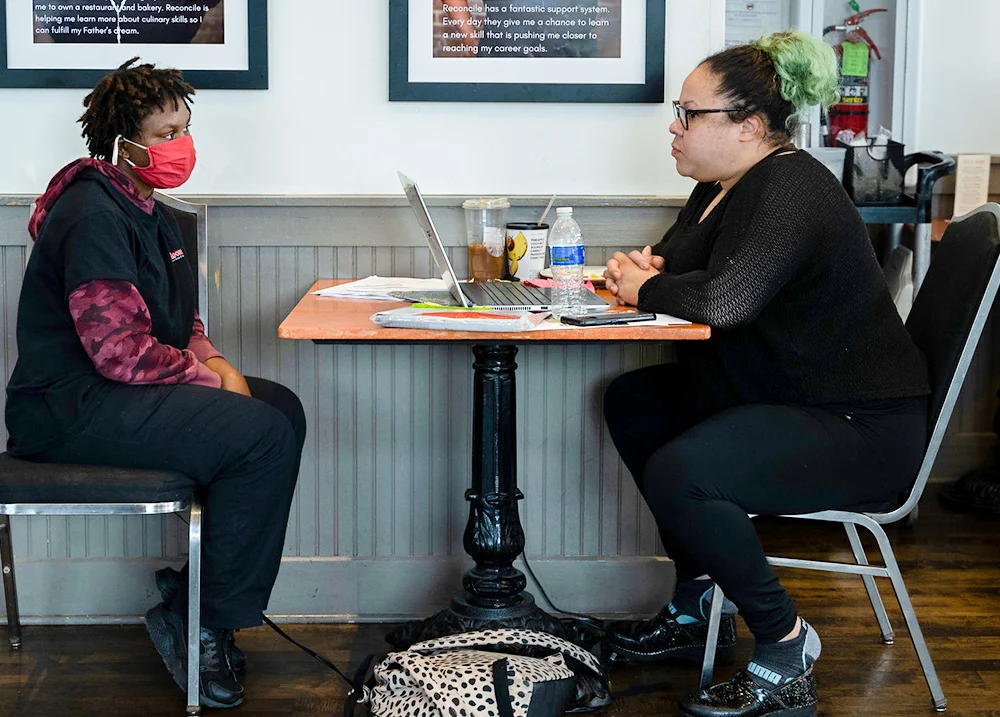 Two people sitting across a table from each other