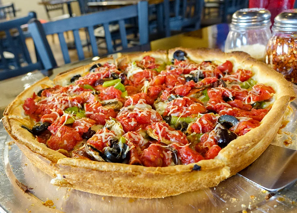 Deep dish pizza on a restaurant table