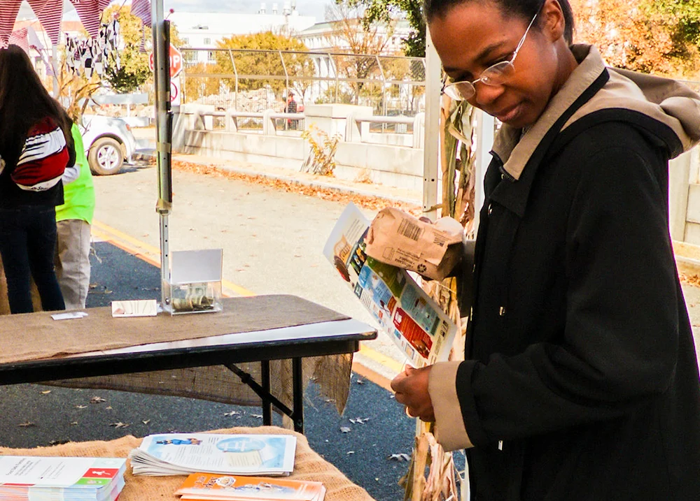 Woman looking at a table of handouts