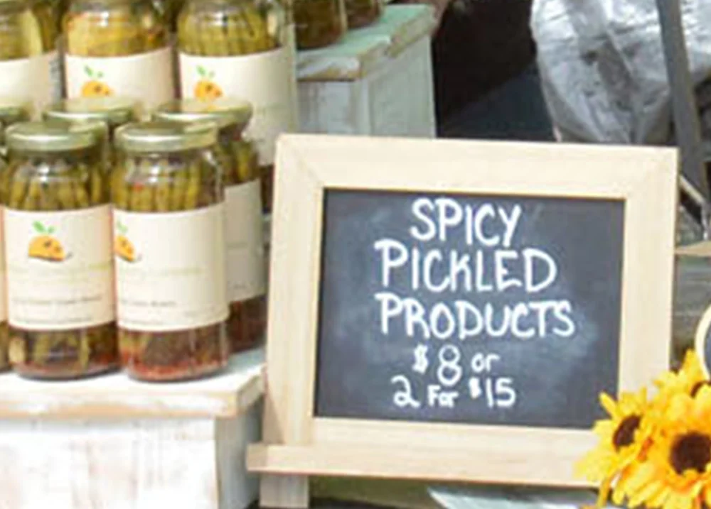 Sign that says Spicy Pickled Products $8 or 2 for $15