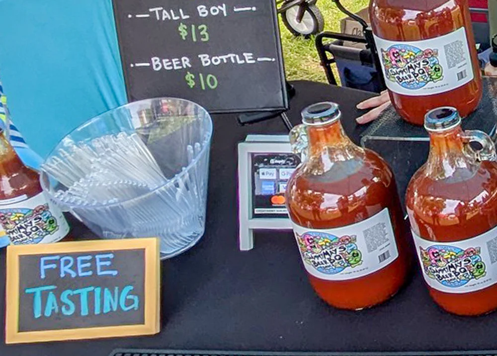 Bottles of sauce with a Free Tasting sign