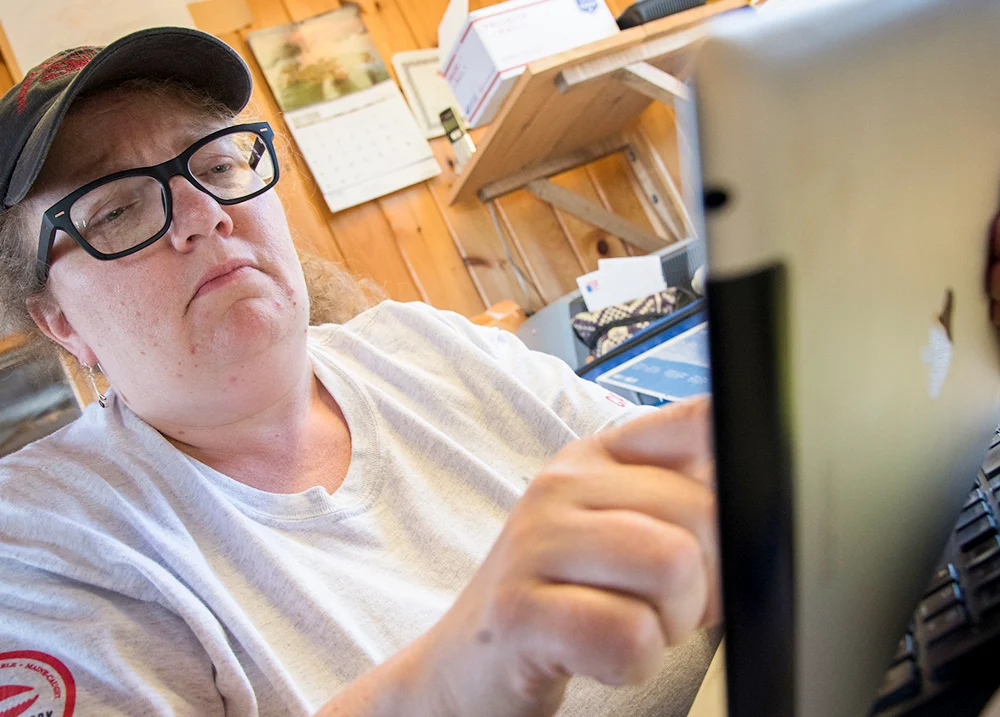 Woman tapping on a digital tablet screen