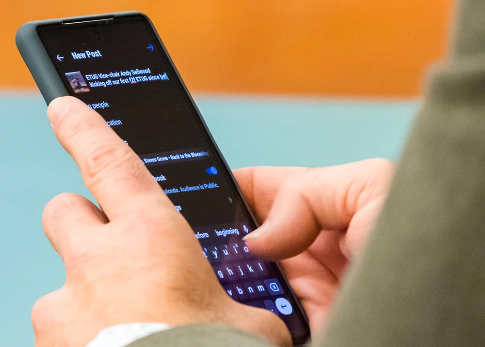 Someone posting on social media from their phone