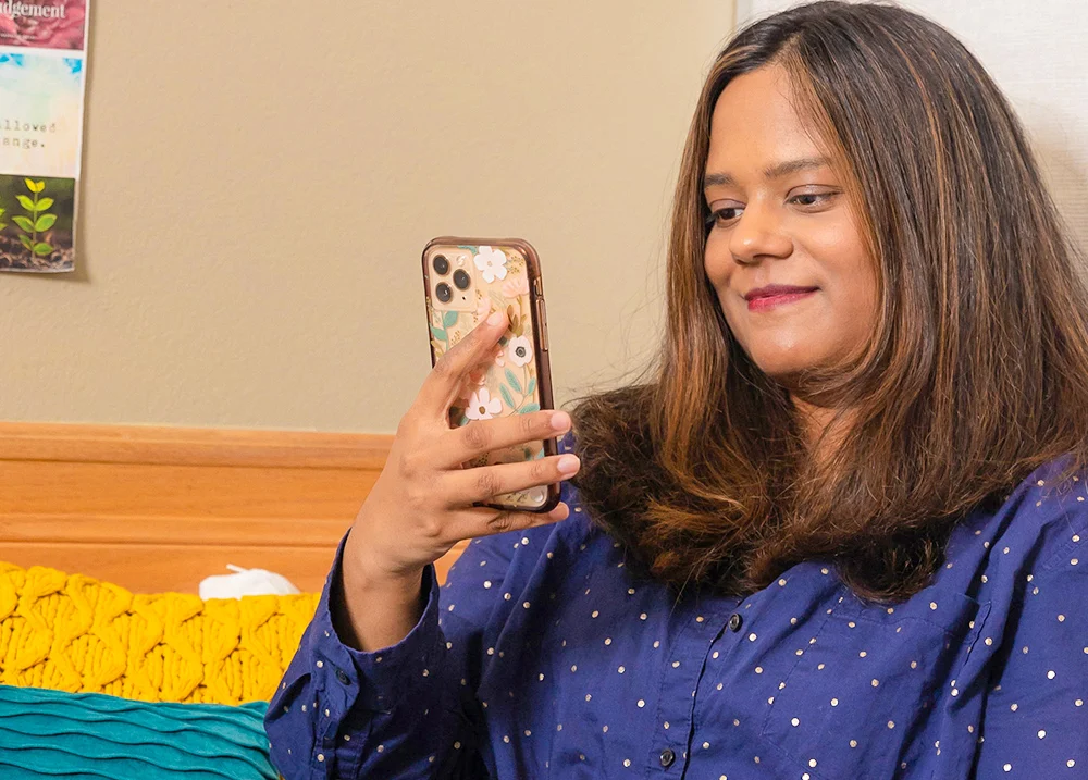 Woman looking at cell phone and smiling