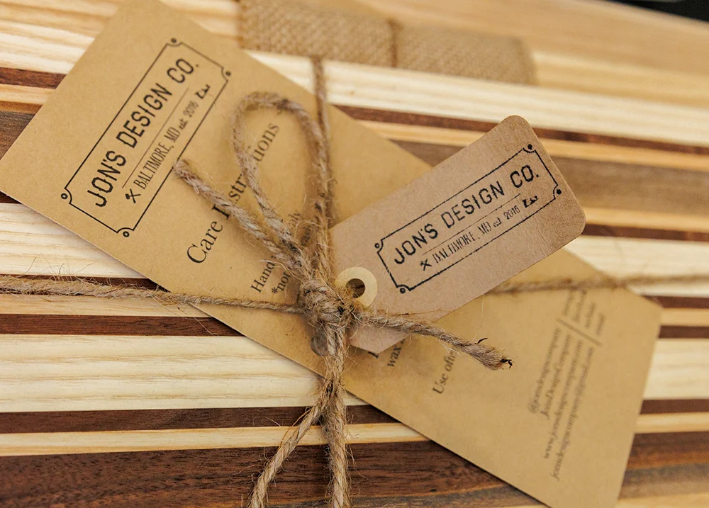 A label that says Jon's Design Co on a wood cutting board