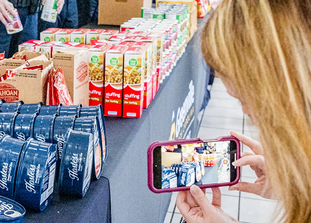 Person taking a photo of food ingredients on a table