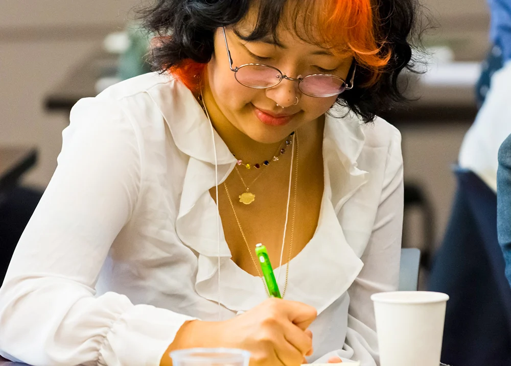 Woman writing on a piece of paper
