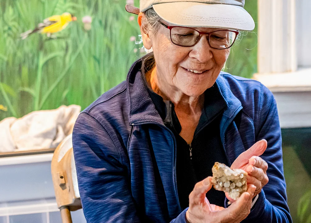 Older woman holding a crystal