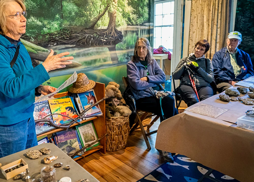 Woman talking to a small group of people in a natural history center