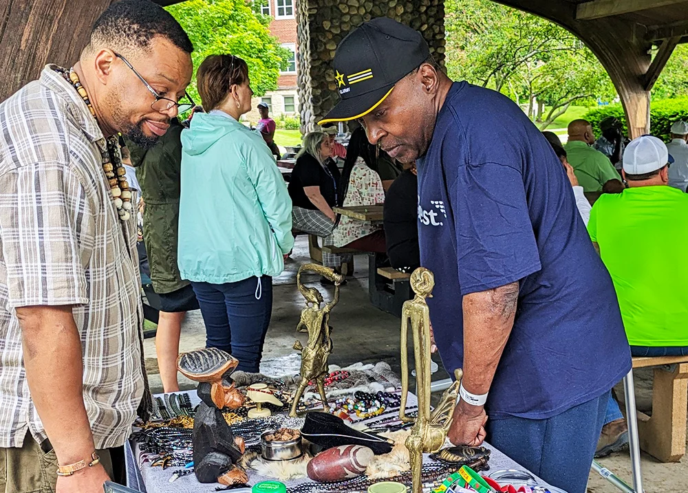 Man selling jewelry at an outdoor event