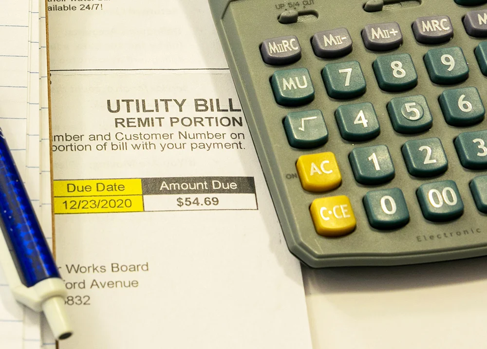 Calculator with a utility bill under it