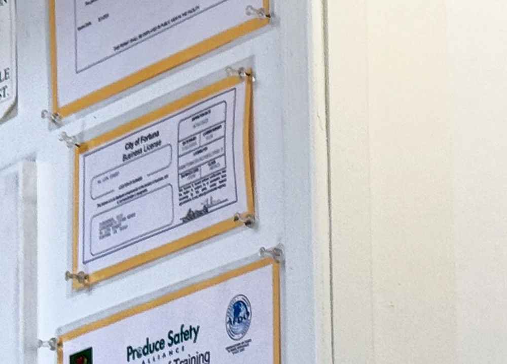 Business licenses hanging on a wall